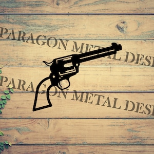May include: A black silhouette of a revolver pistol on a woodgrain background with the text "PARAGON METAL DESIGN" repeated twice.