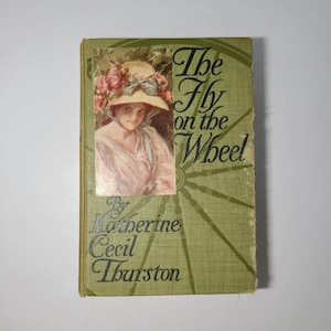 The Fly on the Wheel by Katherine Thurston. Hardcover book published by Grosset & Dunlap 1908.