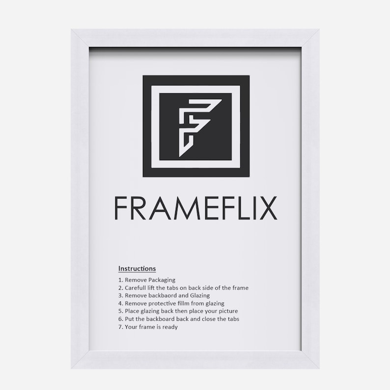 May include: White picture frame with instructions on how to assemble the frame. The instructions include removing packaging, lifting tabs, removing the backboard and glazing, removing protective film, placing the picture, putting the backboard back, and closing the tabs. The frame is ready.