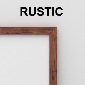 May include: A close-up of the top right corner of a rustic wooden picture frame. The frame is a dark brown color and has a natural wood grain. The word "RUSTIC" is printed in black letters above the frame.