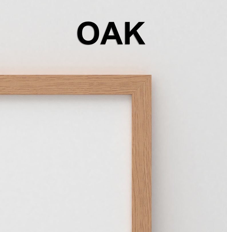 May include: Close-up of the corner of a light wood picture frame. The frame is labeled "OAK" in black text.