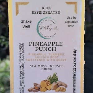 May include: A 16-ounce bottle of pineapple punch with sea moss. The label is white with black text and a logo for Nik Nak Snackz. The bottle is yellow and has a white cap. The ingredients are pineapple juice, turmeric, ginger root, and agave. The drink is sweetened with agave and infused with sea moss.