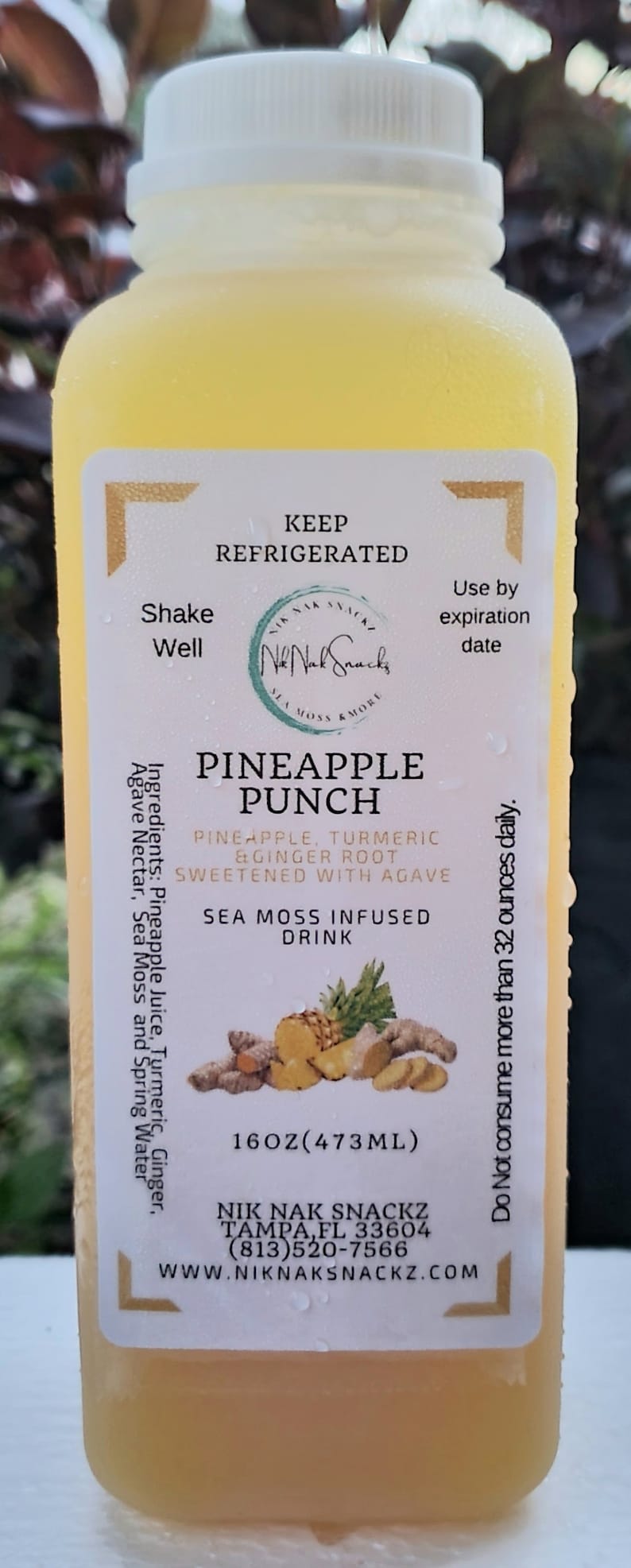 May include: A 16-ounce bottle of pineapple punch with sea moss. The label is white with black text and a logo for Nik Nak Snackz. The bottle is yellow and has a white cap. The ingredients are pineapple juice, turmeric, ginger root, and agave. The drink is sweetened with agave and infused with sea moss.