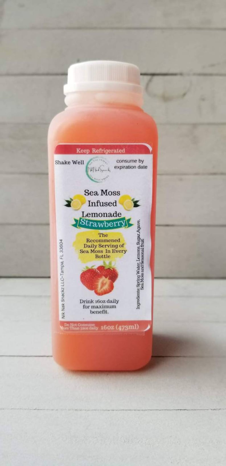 May include: A 473ml bottle of strawberry sea moss infused lemonade. The label reads "Sea Moss Infused Lemonade Strawberry" and includes the recommended daily serving of sea moss in every bottle.  Drink 473ml daily for maximum benefit. Do not consume more than once daily. Keep refrigerated. Shake well. Consume by expiration date.