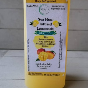 May include: A yellow bottle of Sea Moss Infused Lemonade with Mango flavour. The bottle is labelled with the text "Sea Moss Infused Lemonade Mango" and "The Recommended Daily Serving of Sea Moss In Every Bottle". The bottle is 16oz (473ml).