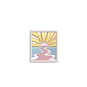 May include: Embroidered square patch featuring a sunset over water. The sun is depicted with yellow rays, a pink center, and a pink and white path leading to the horizon. The water is blue, and the patch has a white border.
