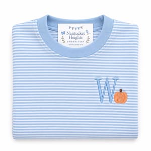 May include: A light blue and white striped long-sleeve shirt with a solid light blue crew neckline. The shirt features an embroidered light blue letter W next to an orange pumpkin. A white label reads Nantucket Heights Embroidery.