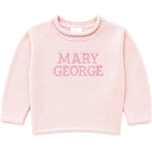 May include: A light pink long-sleeve knit sweater featuring a ribbed crew neckline and cuffs. The text MARY GEORGE is knitted in a slightly darker pink shade across the center of the chest, creating a textured and cohesive appearance.
