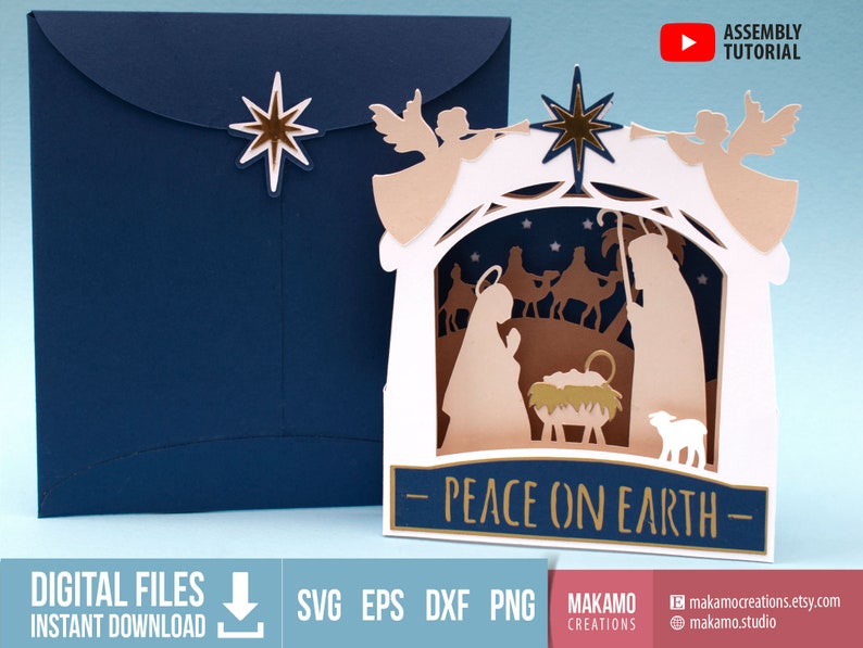 May include: A white papercraft card with a pop-up nativity scene. The scene features a stable with a manger, a star, angels, shepherds, and three wise men. The card has a blue background and the text "Peace on Earth" in gold lettering.