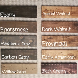 May include: A collection of stained wood samples in various colors. The samples include Ebony, Special Walnut, Briarsmoke, Dark Walnut, Weathered Gray, Provincial, Carbon Gray, Early American, Willow Gray, and Black Cherry. Each sample has the color name in white text.