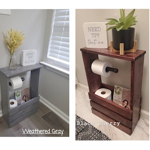 May include: Two wooden toilet paper holders, one weathered gray and one black cherry. Each has a shelf for magazines and a sign that says "NEED TP? text me." The black cherry holder has a plant on top.