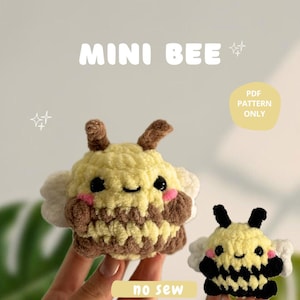 May include: Two crocheted bee plushies, one larger and one smaller. The larger bee is yellow and brown with a smiling face and pink cheeks. The smaller bee is yellow and black with a smiling face and pink cheeks. Both bees have white wings. The text "no sew" is written below the bees.