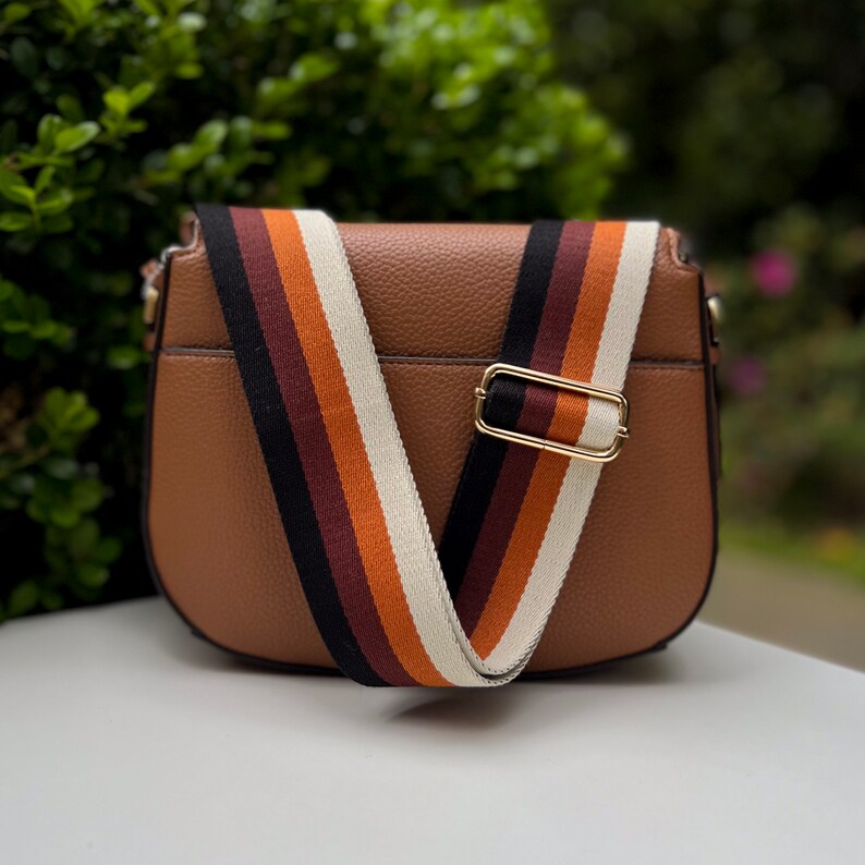 Make any purse, cell phone holder, or camera stylish with this stripe pink beige rose mauve blush black rust orange brown khaki tan sage olive army green blue aqua turquoise forest pine strap gold hardware. This guitar style Boho strap crossbody.