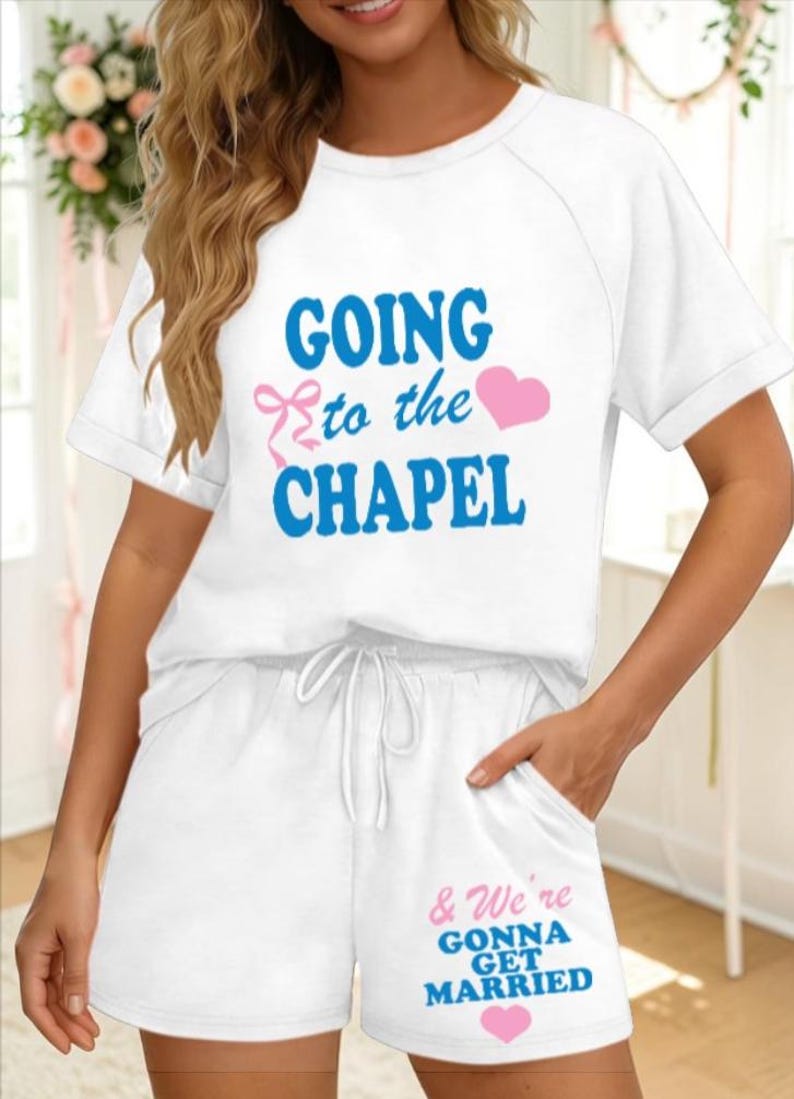May include: White pajama set with the text "GOING to the CHAPEL" in blue and a pink heart and bow. The shorts have the text "& We're GONNA GET MARRIED" in blue and a pink heart. A bridal theme.
