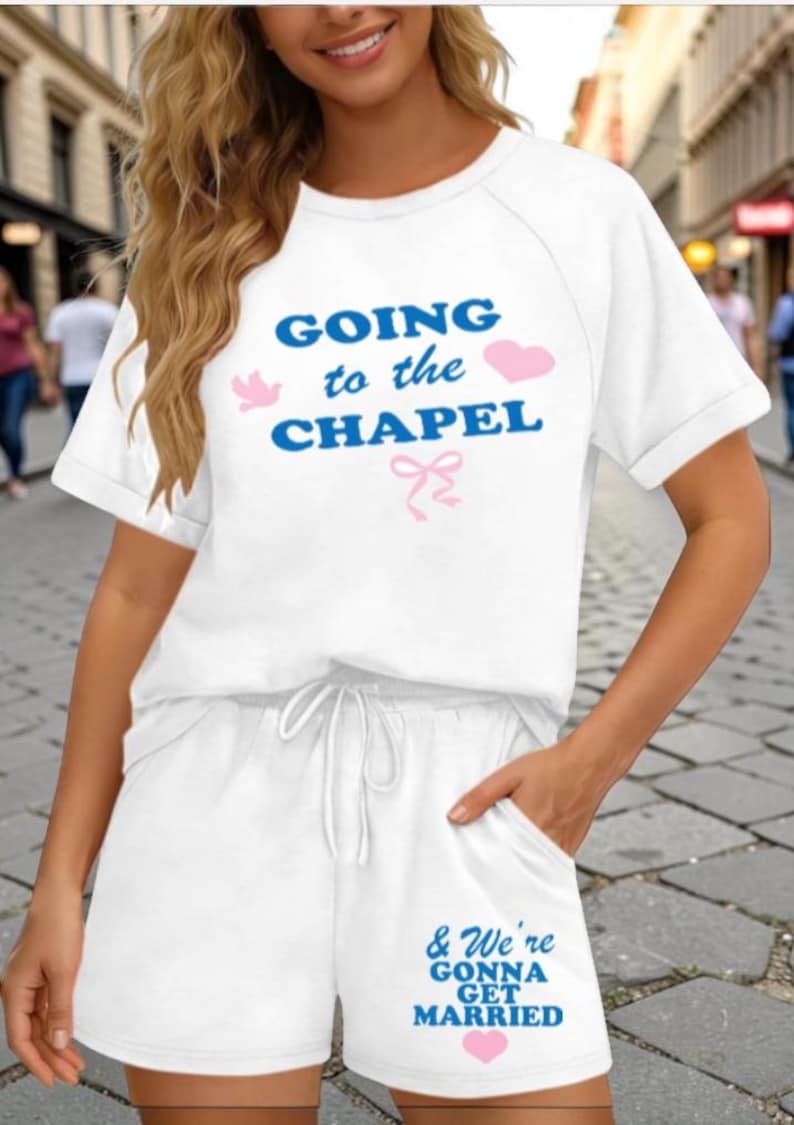 May include: White two-piece pajama set with the text "GOING to the CHAPEL" in blue, with pink accents. The shorts have the text "& We're GONNA GET MARRIED" in blue, with a pink heart. The set is perfect for a wedding.