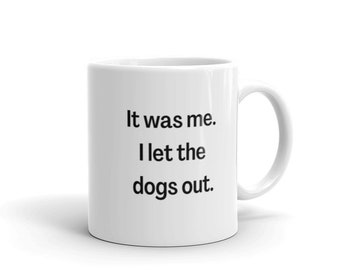 May include: White ceramic coffee mug with black text that reads "It was me. I let the dogs out."