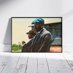 May include: Framed art print featuring two men in suits and hats. One man wears a blue cap, the other a burgundy fedora. The artwork has a vintage aesthetic, with a focus on the figures and their attire.