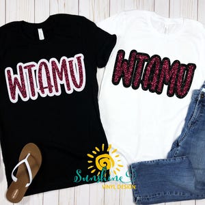May include: Black and white t-shirts with the text "WTAMU" in a glittery maroon font. The black shirt has a white outline around the letters. A pair of brown flip-flops are next to the black shirt. Blue jeans are next to the white shirt.