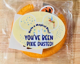 May include: A yellow Mickey Mouse-shaped headband with glitter and the text "Have a Magical Day! You've Been Pixie Dusted!"