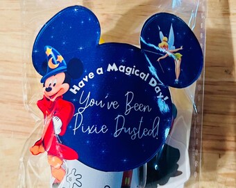 May include: A clear plastic bag with a Mickey Mouse head design. The bag contains a sticker with Mickey Mouse dressed as a wizard, a sticker with Tinkerbell, and a sticker with the text "Have a Magical Day! You've Been Pixie Dusted!"