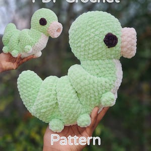 May include: Two plush, green crochet caterpillar toys with white undersides, brown eyes, and pink mouth details are held up. The text "PDF Crochet Pattern" is displayed in white at the top and bottom of the image.