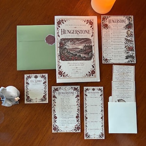 May include: A collection of printed paper items including a Hungerstone book guide, a reading map, a playlist, a bookmark, an Ex Libris card, and several sealed envelopes, all featuring floral borders and vintage-style typography.