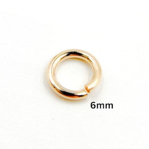 May include: A gold-colored jump ring with a 6mm diameter.