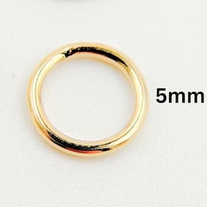 May include: A gold-colored jump ring with a 5mm diameter.