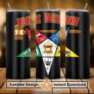 May include: A black tumbler with a design featuring a Masonic symbol, the words "Past Matron" and a compass and square. The tumbler is on a wooden surface.