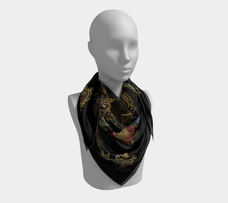 May include: A black silk scarf with a gold and floral pattern. The scarf is folded and draped around a mannequin's neck.