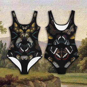 May include: Black swimsuit with a butterfly pattern. The butterflies are in shades of yellow, green, blue, and red.