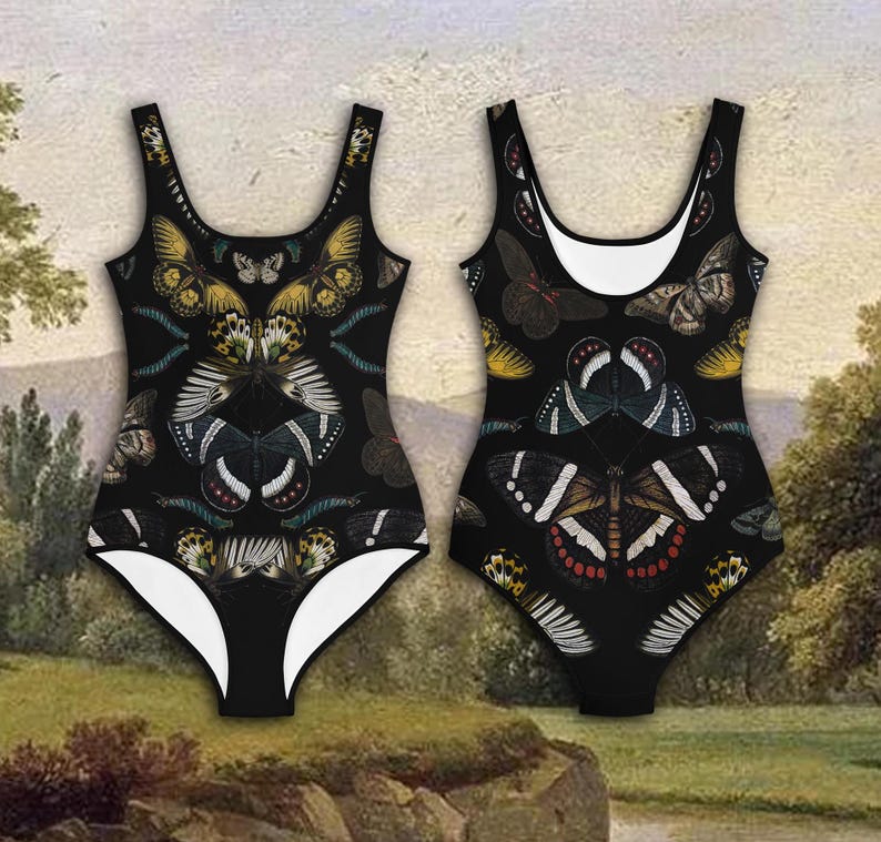 May include: Black swimsuit with a butterfly pattern. The butterflies are in shades of yellow, green, blue, and red.