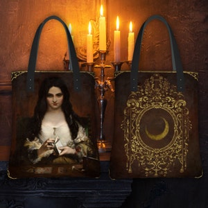 May include: Two tote bags with different designs. The bag on the left features a painting of a woman holding a letter. The bag on the right features a gold ornate frame with a crescent moon inside.