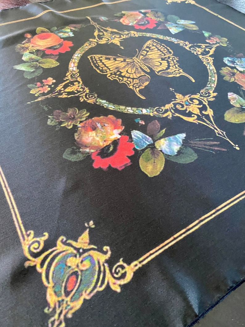 Black scarf with victorian style artwork border and flowers with a golden butterfly in the center