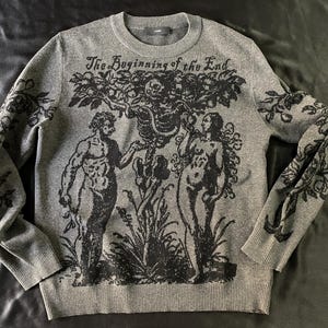 May include: A grey sweater with a black print of a tree with two figures and the text "The Beginning of the End".