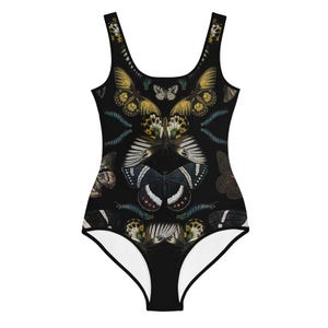 May include: Black one-piece swimsuit with a colorful butterfly print. The butterflies are arranged in a symmetrical pattern.