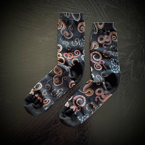 May include: A pair of black socks with a colorful snake print. The socks are made of a soft, comfortable material and are perfect for everyday wear.
