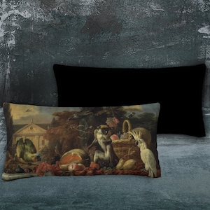 Puede incluir: Una almohada rectangular con una pintura vintage de un mono, un loro y una cesta de fruta. La pintura está ambientada en un jardín con un edificio en la distancia.