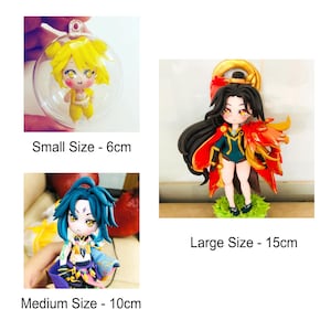 May include: Three handmade polymer clay figurines of anime characters in different sizes. The smallest figurine is 6 cm tall and is inside a clear sphere. The medium figurine is 10 cm tall and has blue hair. The largest figurine is 15 cm tall and has long black hair with a red cape.