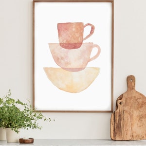 May include: A watercolor painting of three stacked cups in shades of pink and yellow. The cups are arranged in a simple, modern style.