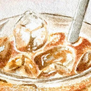 May include: A close-up of a glass of iced coffee with ice cubes and a straw. The coffee is a light brown color and the ice cubes are clear.