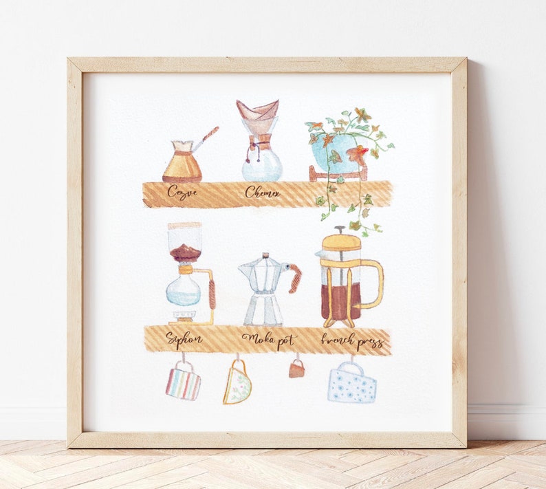 May include: A watercolor illustration of different coffee brewing methods, including a Chemex, a French press, a siphon, a Moka pot, and a Cozy. The illustration is framed in a light wood frame and includes the names of each brewing method.