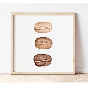 May include: Three watercolour illustrations of coffee beans, each in a different stage of roasting. The top bean is light brown, the middle bean is medium brown, and the bottom bean is dark brown.