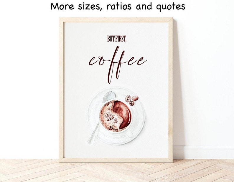 May include: A white framed print with the text "But first, coffee" in brown lettering. The print features a watercolor illustration of a cup of coffee with a spoon and a few coffee beans.
