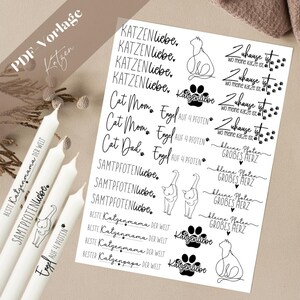 Könnte beinhalten: Ein Blatt mit schwarz-weißen, druckbaren Aufklebern mit verschiedenen Katzenmotiven. Die Aufkleber enthalten Sätze wie "Cat Mom", "Cat Dad", "Samtpfoetenliebe", "Zuhause ist wo meine Katze ist" und "Engel auf 4 Pfoten".