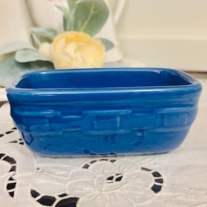 May include: A set of three ceramic mugs with a speckled, matte finish. The mugs are in shades of cream, light gray, and dark gray. Each mug has a simple, minimalist design and a rounded handle.