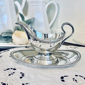 May include: A set of three ceramic mugs with a speckled, matte finish. The mugs are in shades of cream, light gray, and dark gray. Each mug has a simple, minimalist design, perfect for coffee or tea.