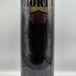 May include: A black and silver tumbler with a black and white graphic of a graduation cap and the word "FORTA".