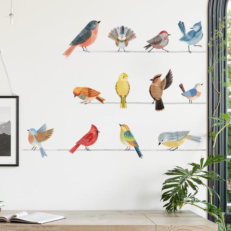 May include: A collection of colorful bird decals in various poses, perched on thin, horizontal lines against a white wall. The birds feature a range of colors, including red, blue, yellow, and orange, creating a vibrant and cheerful aesthetic.