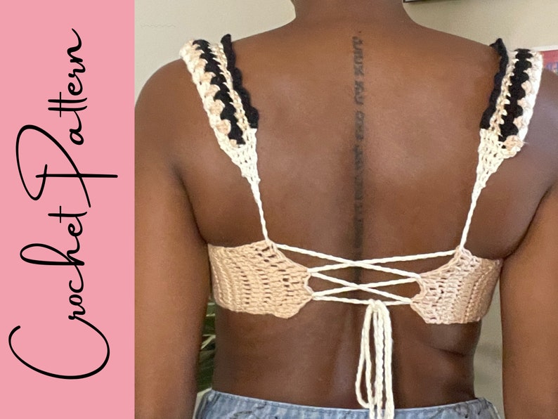 May include: A crochet top with a white and black striped trim and a tie back. The top is made with a beige yarn.